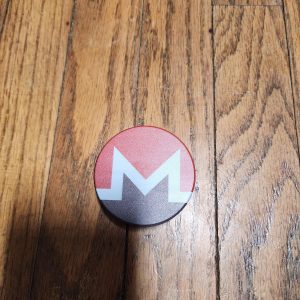 top of a two-piece Monero themed grinder